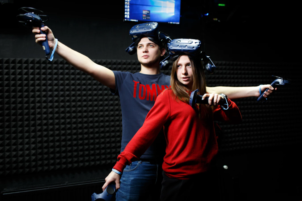 Two teenagers playing with Virtual Reality headsets